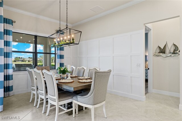 tiled dining area with ornamental molding and a chandelier