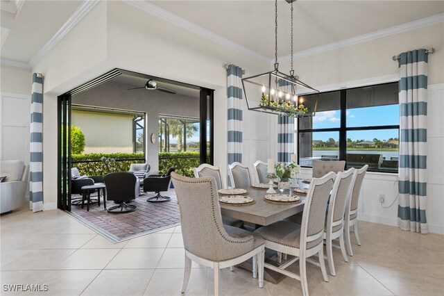 dining area featuring a chandelier, light tile patterned floors, and crown molding