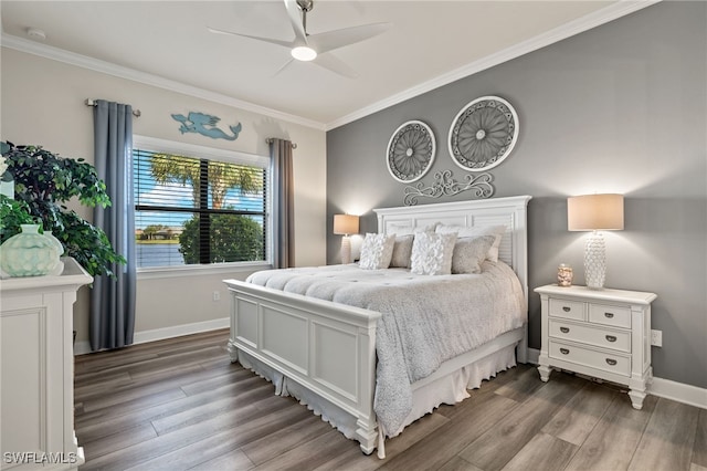 bedroom featuring ceiling fan, crown molding, and dark wood-type flooring