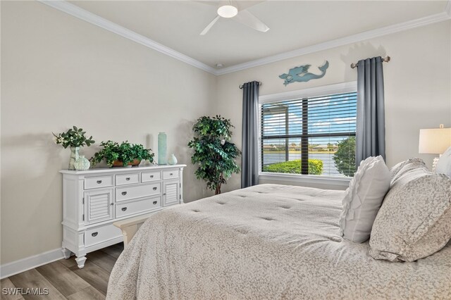 bedroom with ceiling fan, wood-type flooring, and ornamental molding