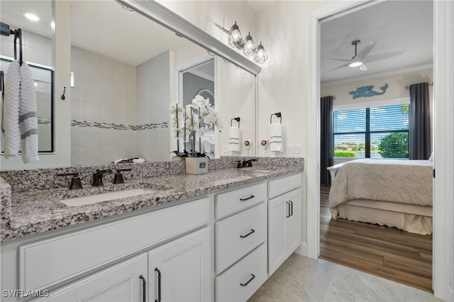 bathroom with ceiling fan, vanity, wood-type flooring, and ornamental molding