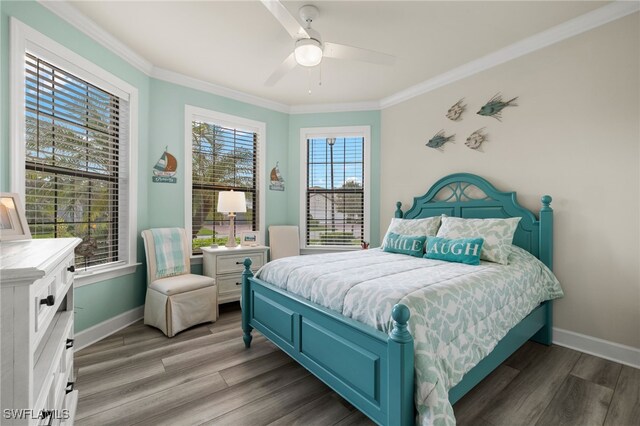 bedroom featuring ceiling fan, hardwood / wood-style floors, and crown molding