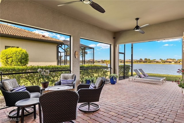 view of patio / terrace featuring ceiling fan and a water view