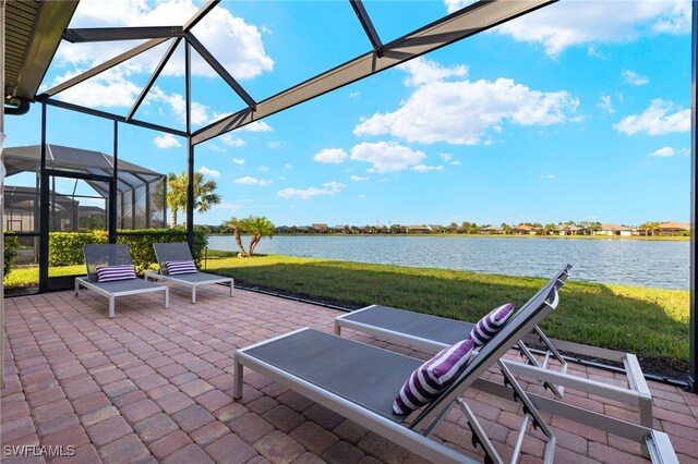 view of patio / terrace featuring glass enclosure and a water view