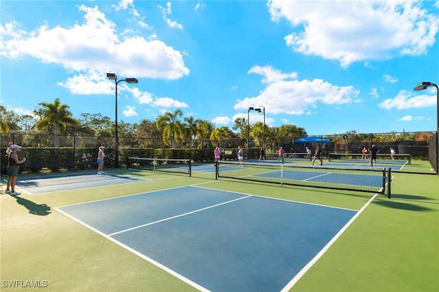 view of tennis court with basketball hoop