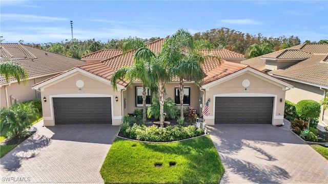 mediterranean / spanish house featuring a garage