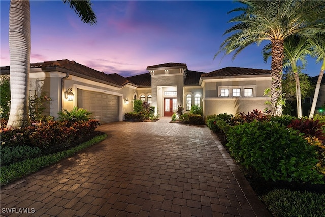 mediterranean / spanish-style house with a garage