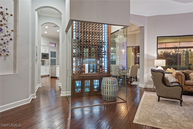 interior space featuring ornamental molding and dark hardwood / wood-style flooring