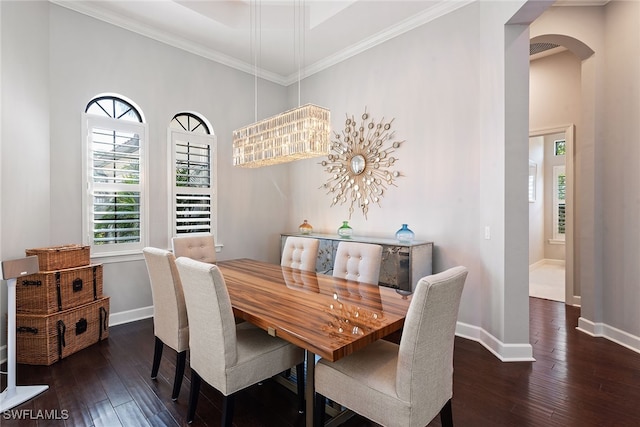 dining room with ornamental molding, a high ceiling, and dark hardwood / wood-style flooring