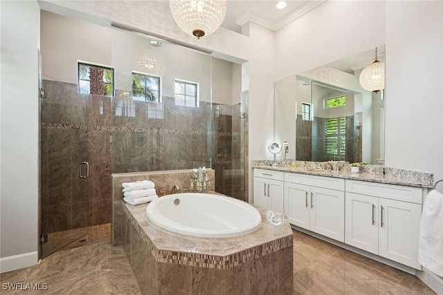 bathroom featuring vanity, ornamental molding, and shower with separate bathtub