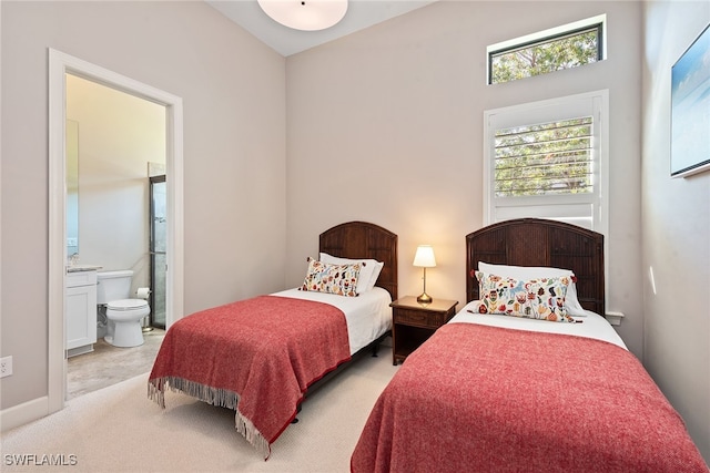 carpeted bedroom featuring ensuite bath