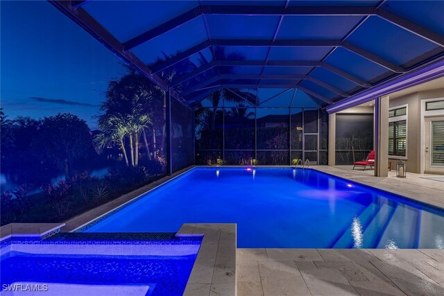 view of swimming pool with a patio and a lanai