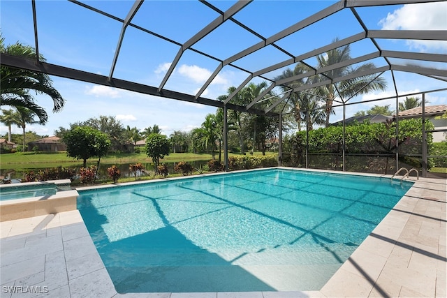 view of pool featuring a patio area, a water view, and glass enclosure