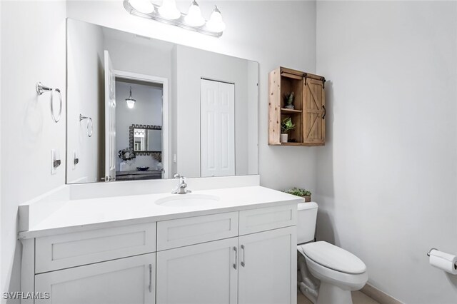 bathroom featuring vanity and toilet