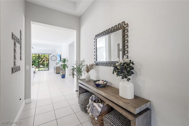 hall featuring light tile patterned flooring