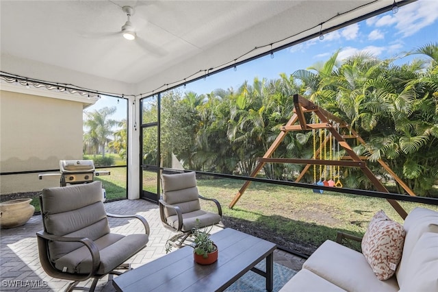 sunroom / solarium featuring ceiling fan