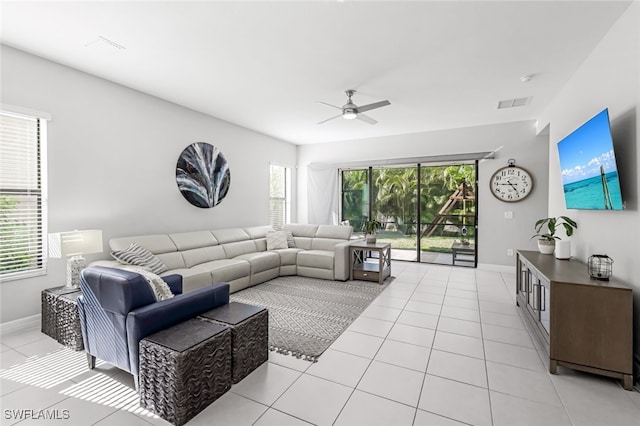 tiled living room featuring ceiling fan