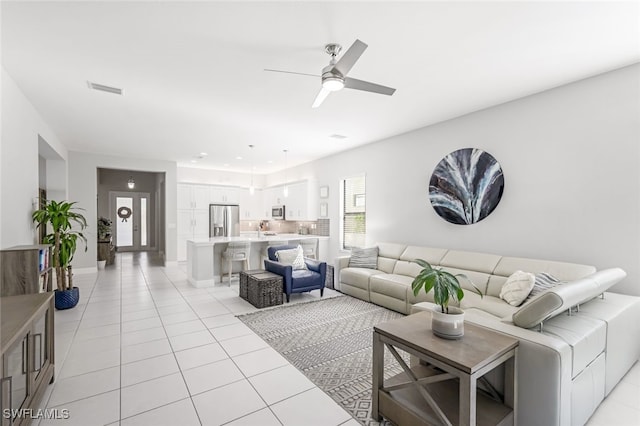 living area with light tile patterned floors, visible vents, a ceiling fan, and recessed lighting