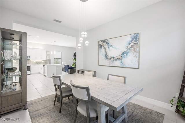 dining room with sink and light tile patterned floors