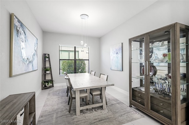 dining space with an inviting chandelier and light tile patterned floors