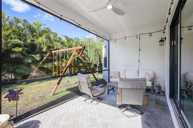 sunroom / solarium featuring ceiling fan