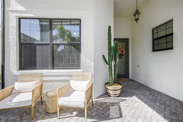 doorway to property featuring stucco siding