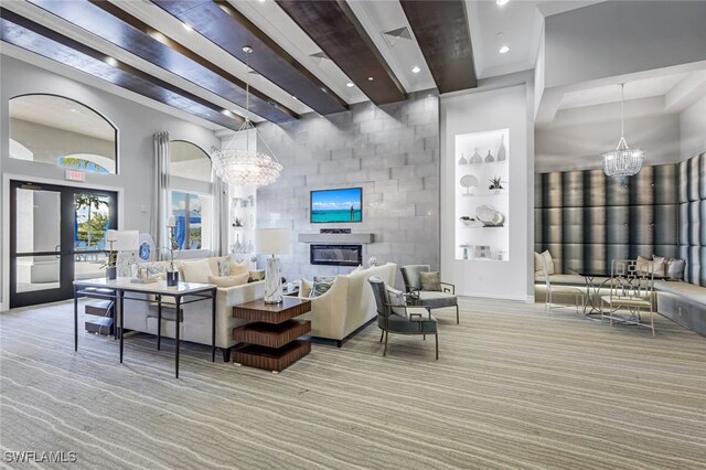 carpeted living room with built in shelves, beam ceiling, french doors, a chandelier, and a towering ceiling