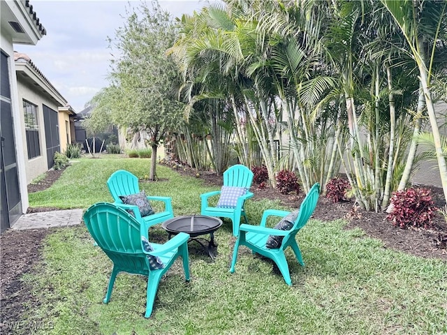 view of yard with a fire pit