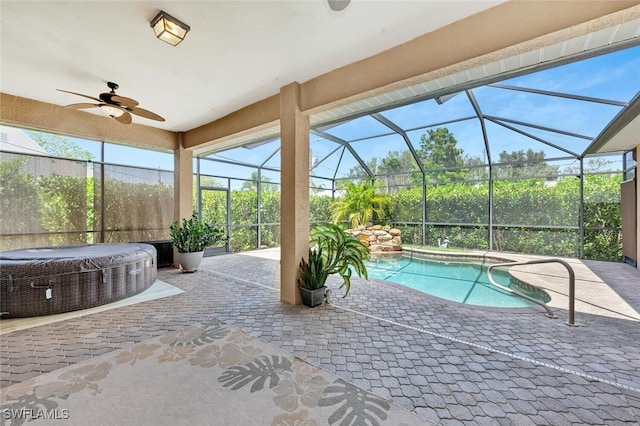 view of swimming pool featuring ceiling fan, a patio area, and glass enclosure