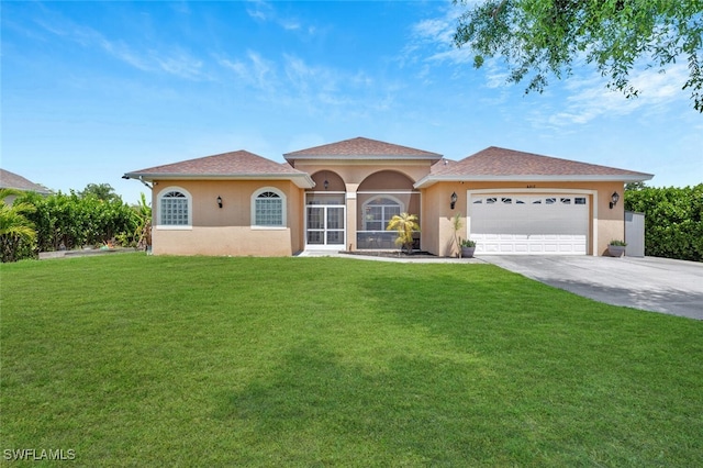 mediterranean / spanish home featuring a garage and a front lawn