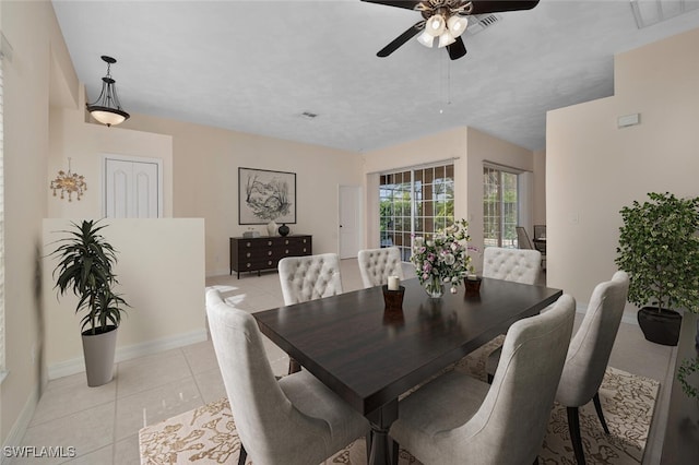 tiled dining room featuring ceiling fan