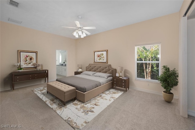 bedroom featuring ensuite bath, ceiling fan, and light colored carpet