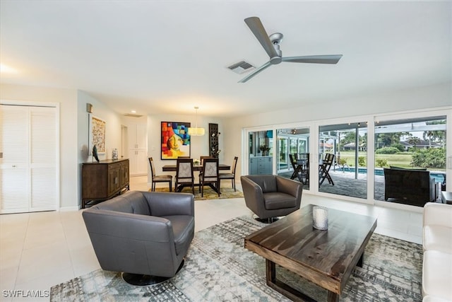 living room with light tile patterned floors and ceiling fan