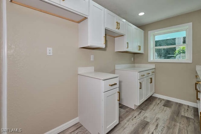 kitchen with white cabinets and light wood-type flooring