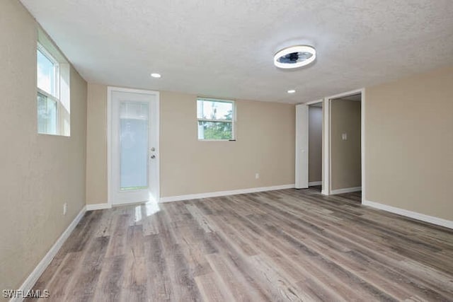 interior space featuring wood-type flooring and a textured ceiling