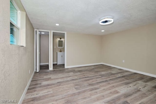 interior space featuring light hardwood / wood-style floors and a textured ceiling