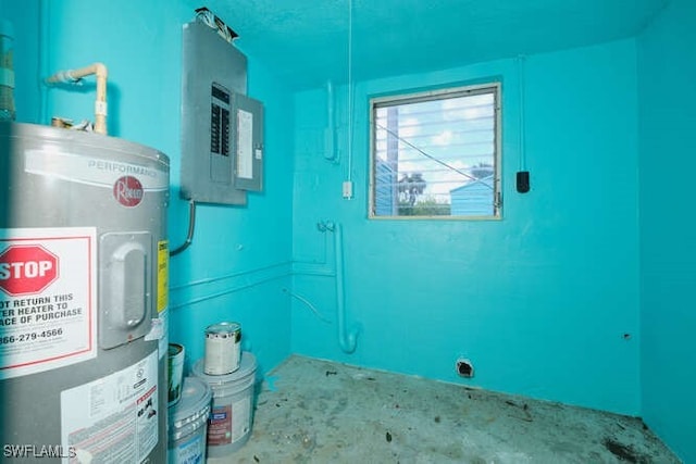 utility room featuring electric panel and electric water heater