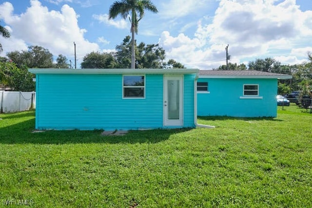 rear view of house with a lawn