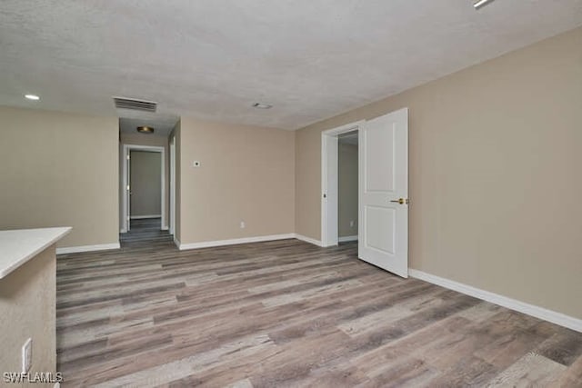 unfurnished room with hardwood / wood-style flooring