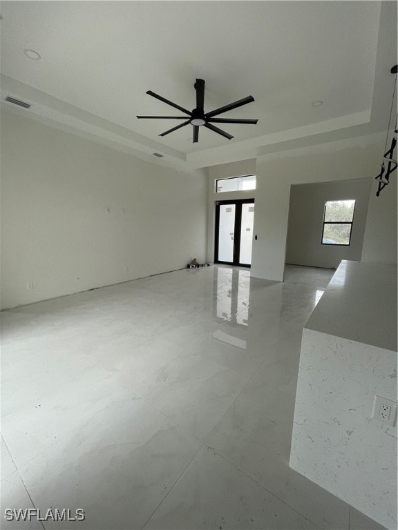 unfurnished room featuring french doors and ceiling fan