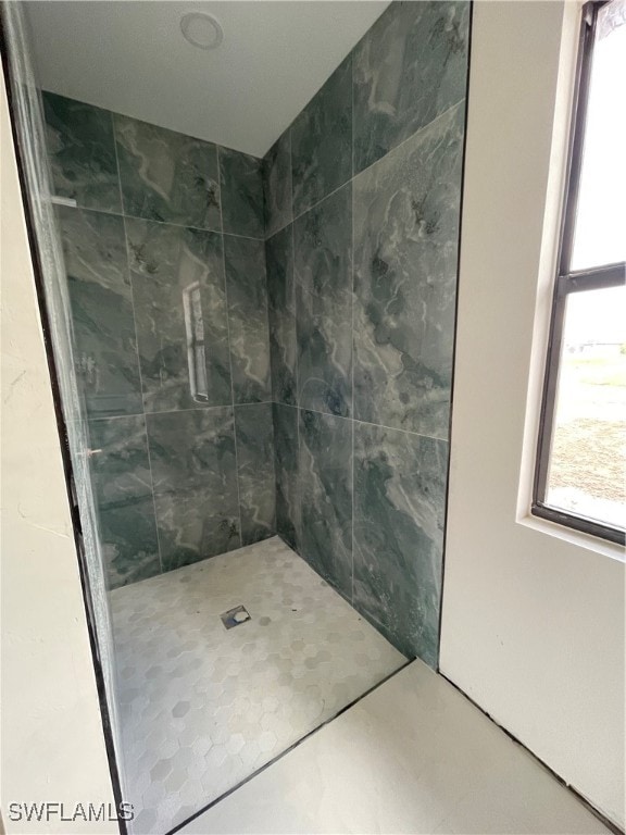 bathroom with tiled shower