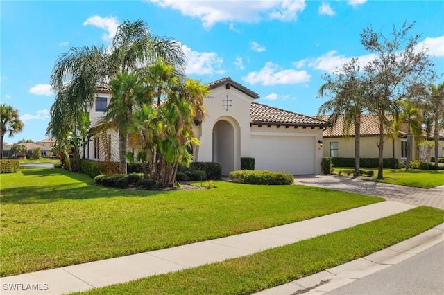 mediterranean / spanish home featuring a garage, a tile roof, driveway, stucco siding, and a front yard