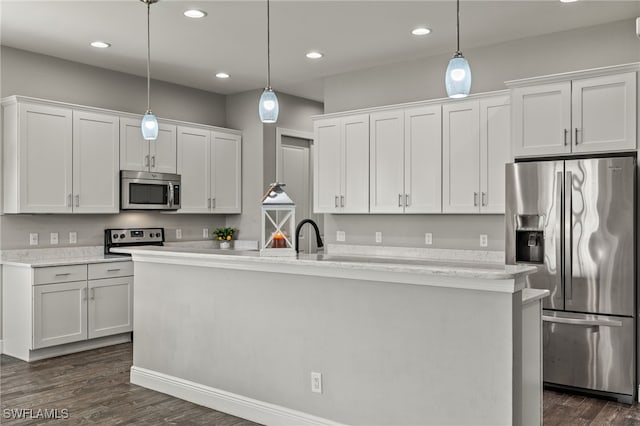 kitchen with appliances with stainless steel finishes, white cabinetry, and dark wood finished floors