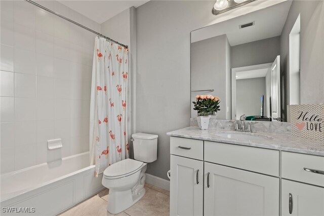 full bathroom featuring toilet, visible vents, vanity, tile patterned floors, and shower / bath combo with shower curtain