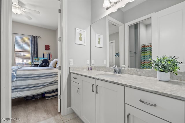 full bath featuring tile patterned floors, ensuite bath, a ceiling fan, and vanity