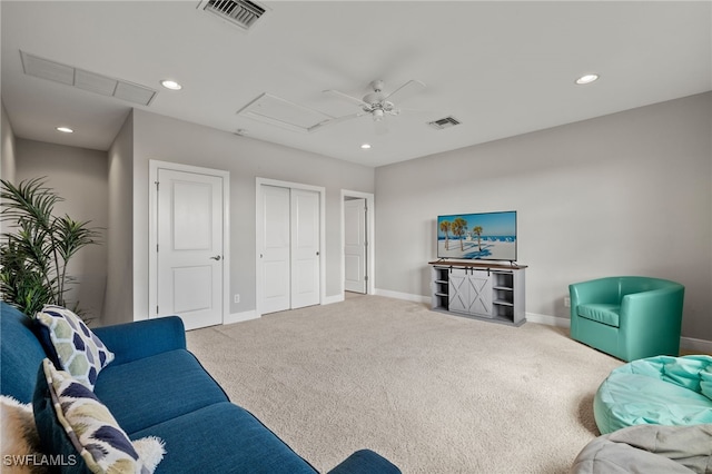 carpeted living area with attic access, recessed lighting, and visible vents