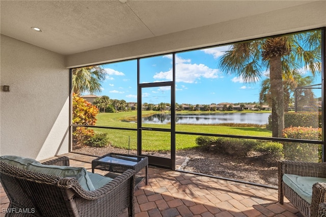 sunroom / solarium with a water view