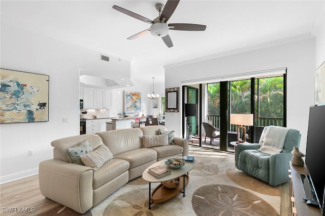 living room featuring light hardwood / wood-style floors, ceiling fan with notable chandelier, and ornamental molding