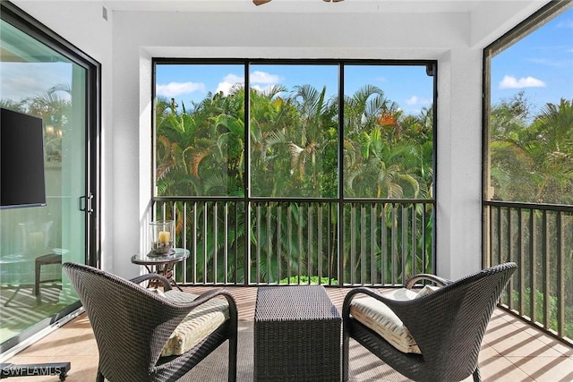 sunroom featuring ceiling fan