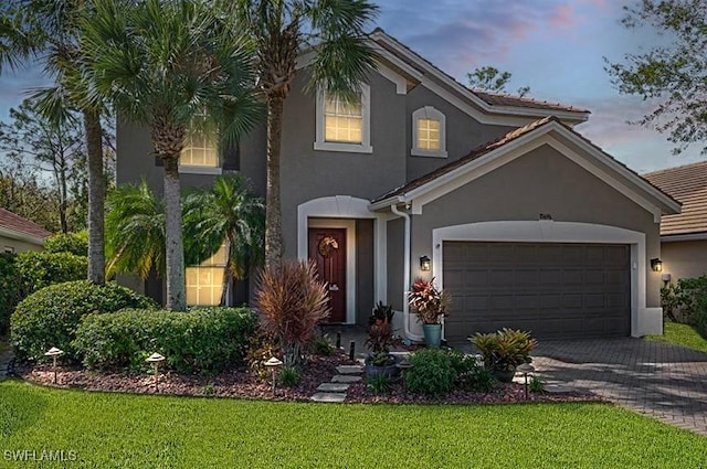 view of front of house featuring a garage and a yard